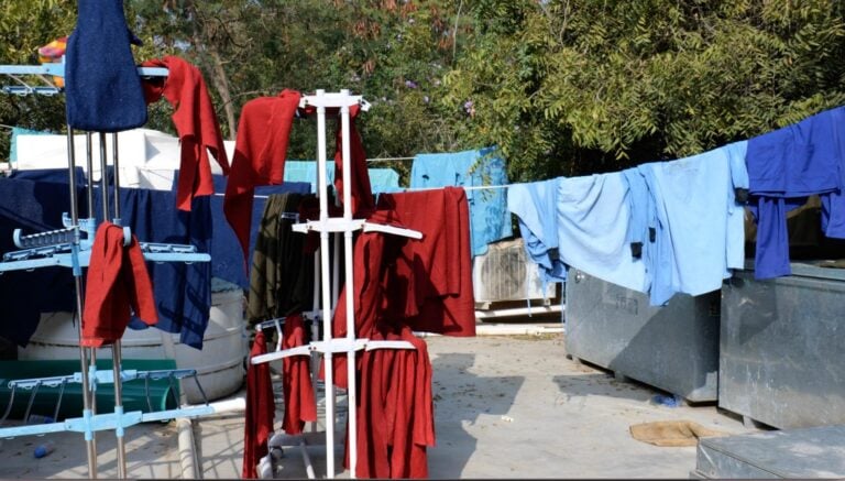 A washing line full of sheets, uniforms and blankets